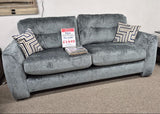 Grey sofa with price tag in a store setting