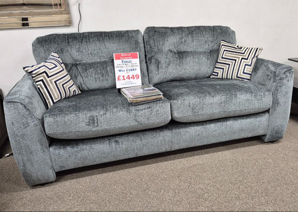Grey sofa with price tag in a store setting