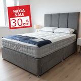 Gray upholstered bed with white mattress in a bedroom setting, featuring a 'Mega Sale 30% Off' sign.